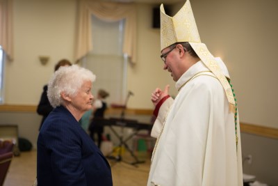 CSJ Sister greeting His Excellency Most Reverend Bishop Miehm
