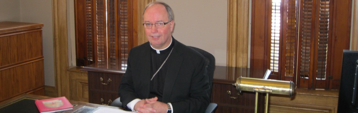 Bishop Miehm sitting at his desk