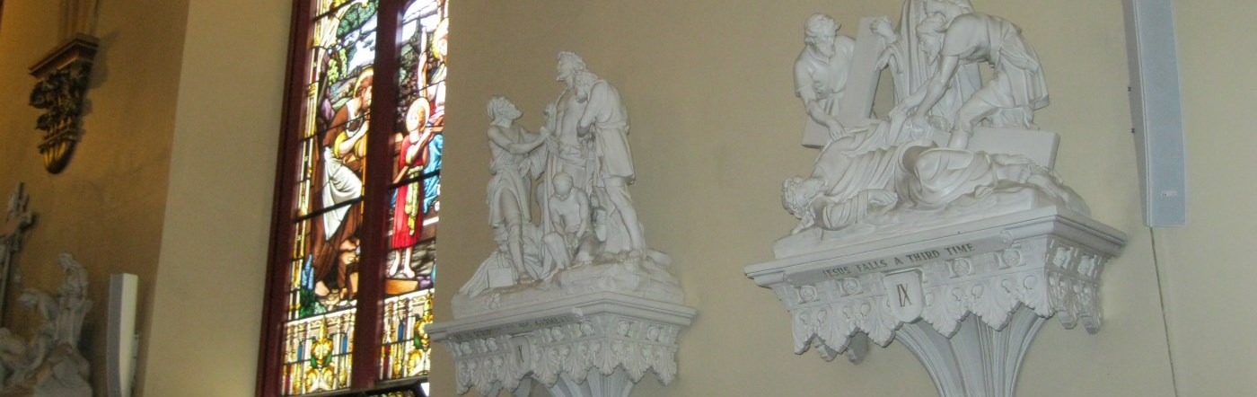 View in the cathedral of a station of the cross and stained glass window