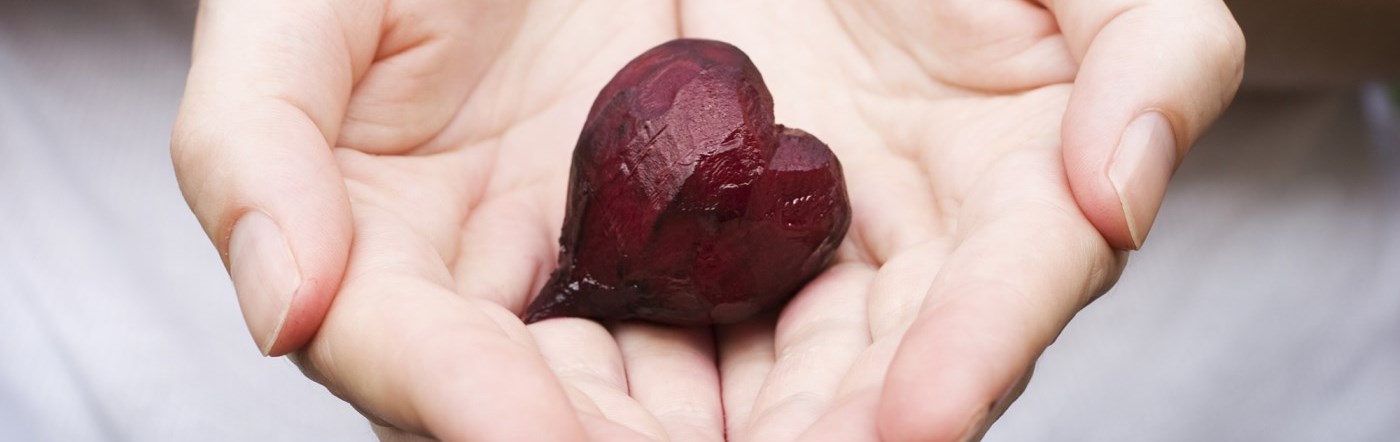 Hands outstretched offering a heart image