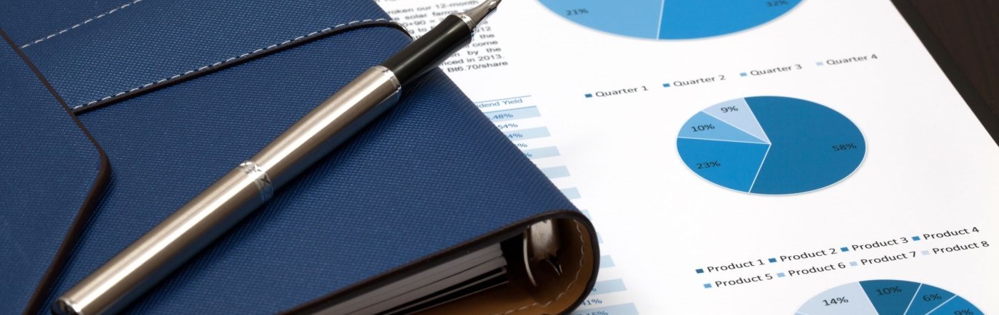 Pen with financial reports