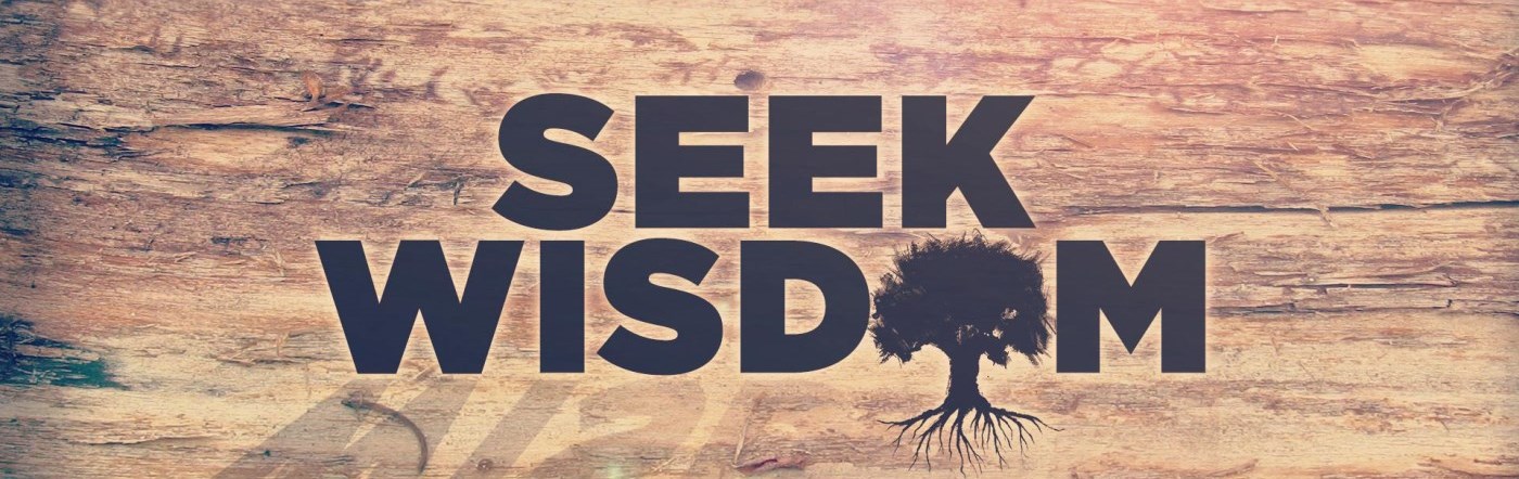 Words "seek wisdom" are etched on a piece of wood