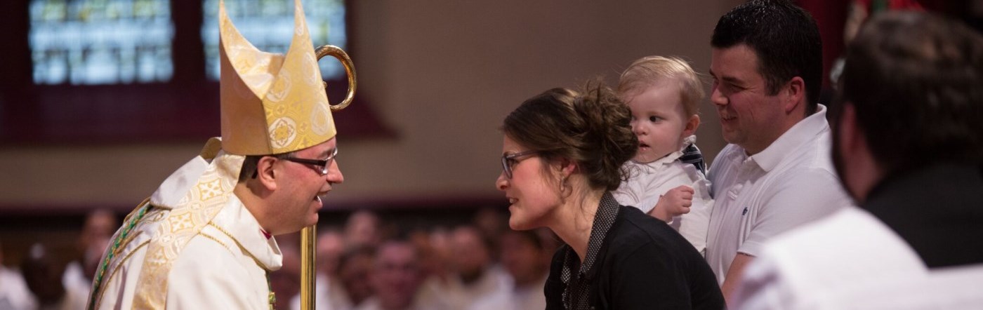Family speaking with Most Rev. Bishop Miehm