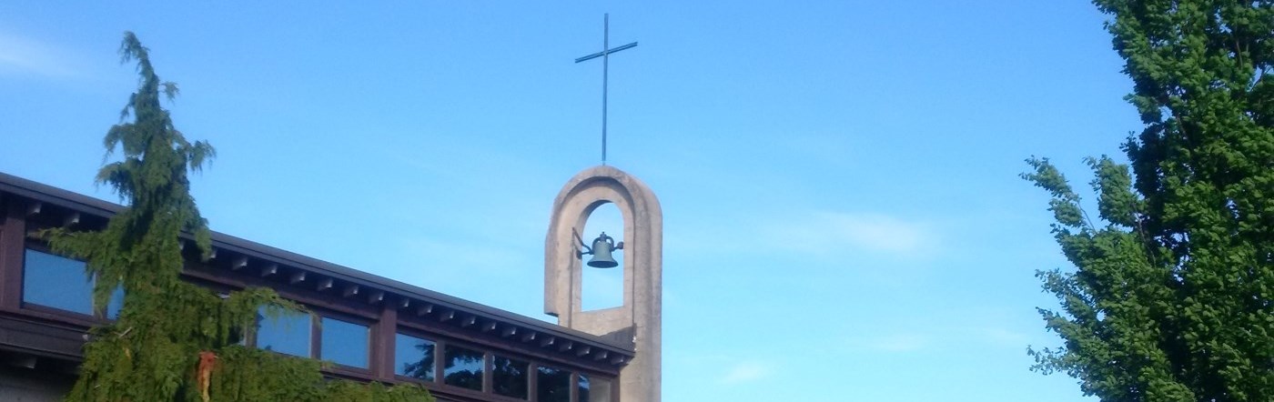 Cross of a retreat centre against a blue sky