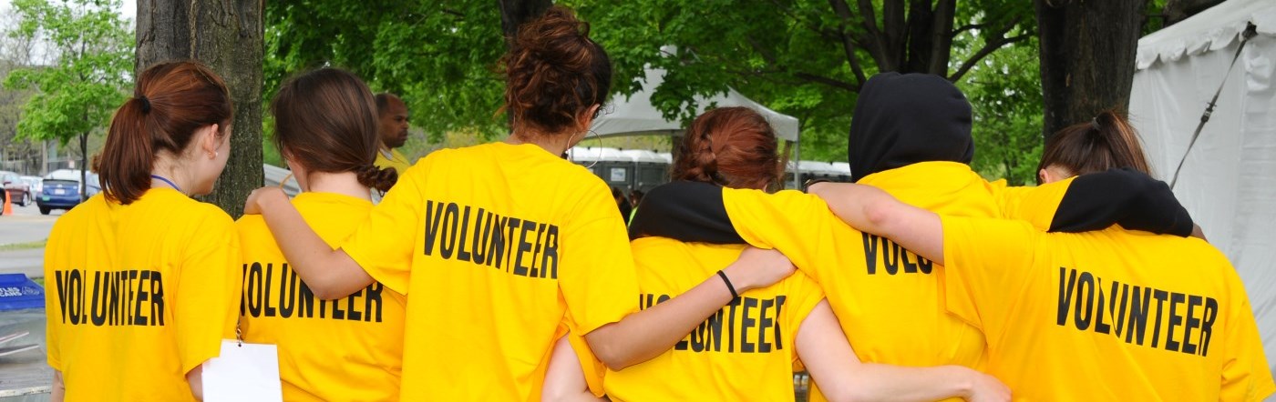 Group of volunteers with yellow t-shirts on